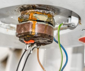 closeup of a rusty and leaking water heater