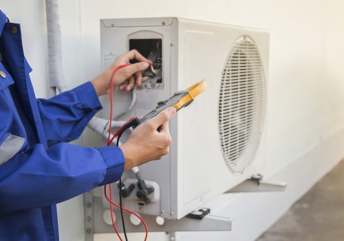 Technician checking the operation of the air conditioner