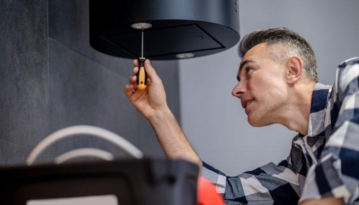 backlight-adjustment-man-with-screwdriver-hanging-wall-twisting-adjusting-lighting_259150-59263