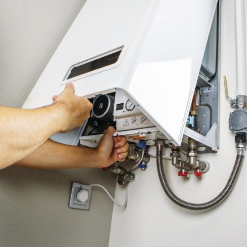 plumber-attaches-trying-fix-problem-with-residential-heating-equipment-repair-gas-boiler-1