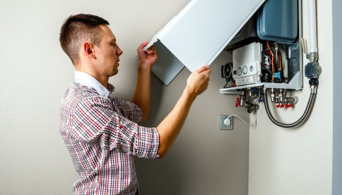 plumber-attaches-trying-fix-problem-with-residential-heating-equipment-repair-gas-boiler_93200-3026
