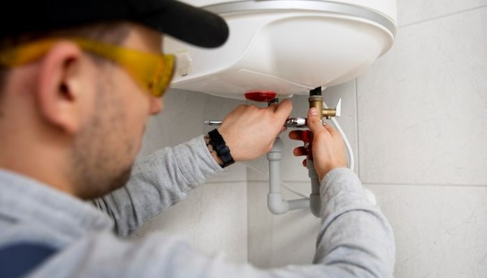 worker-repairing-water-heater_23-2149334231