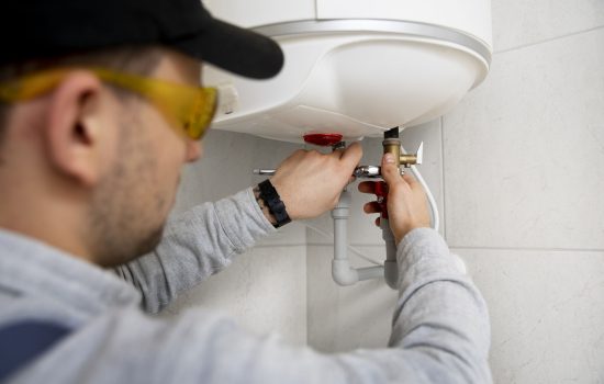 worker-repairing-water-heater_optimized_1000