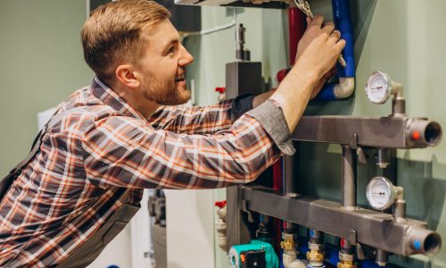 Young engineer adjusting autonomous heating
